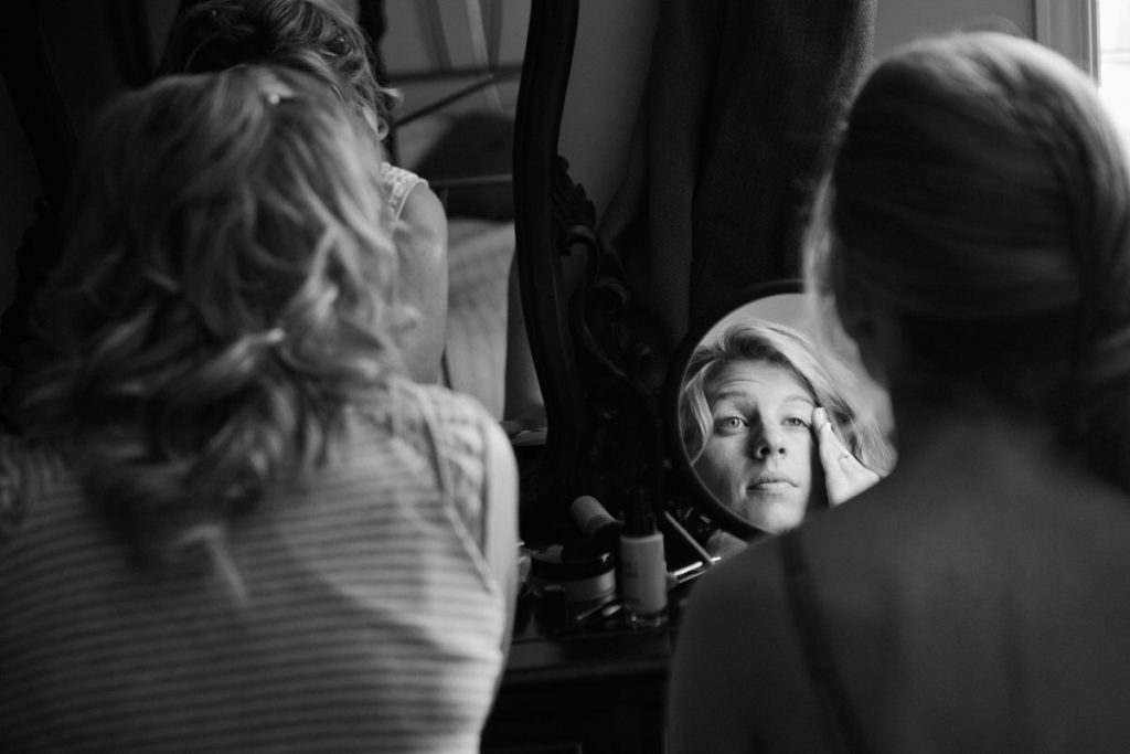 Bride doing her makeup