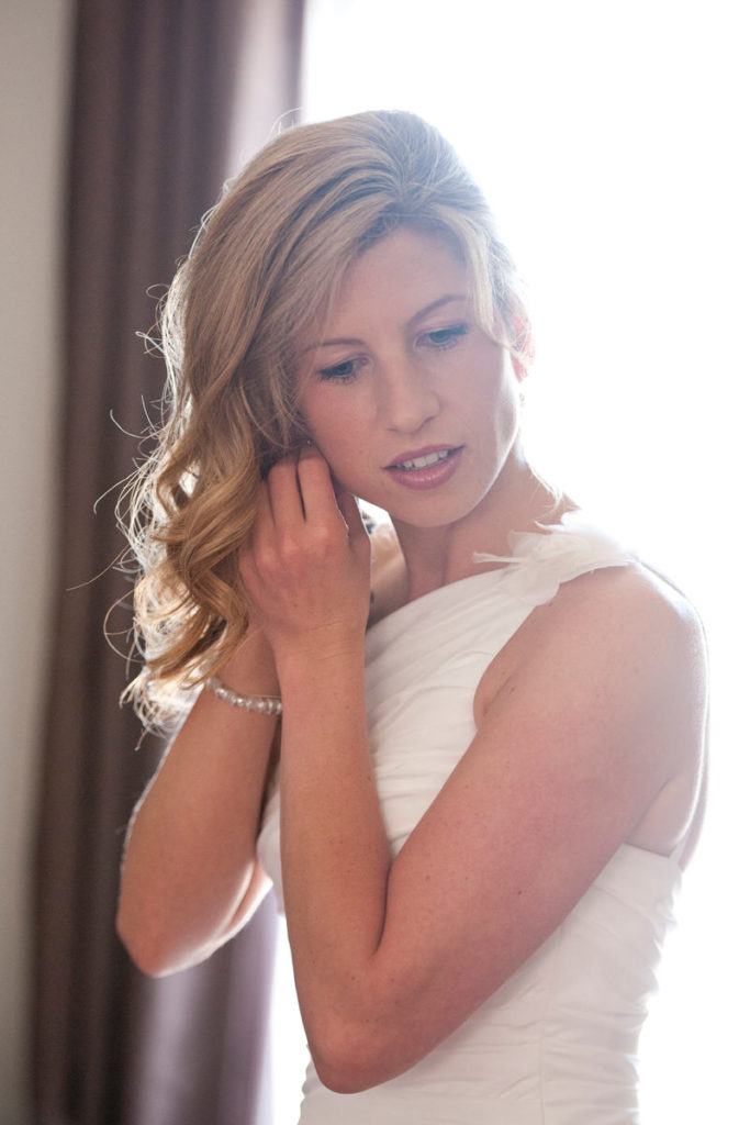 Bride doing her earring