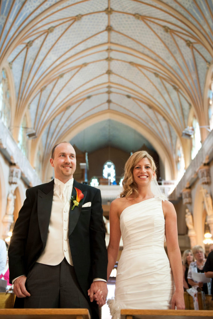 Bride and groom holding hands during wedding ceremony