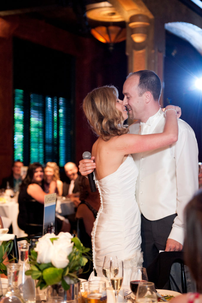 Wedding couple kissing during speech