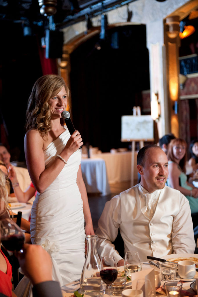 Bride speaking into a mike at Cabaret Lion d'Or wedding dinner