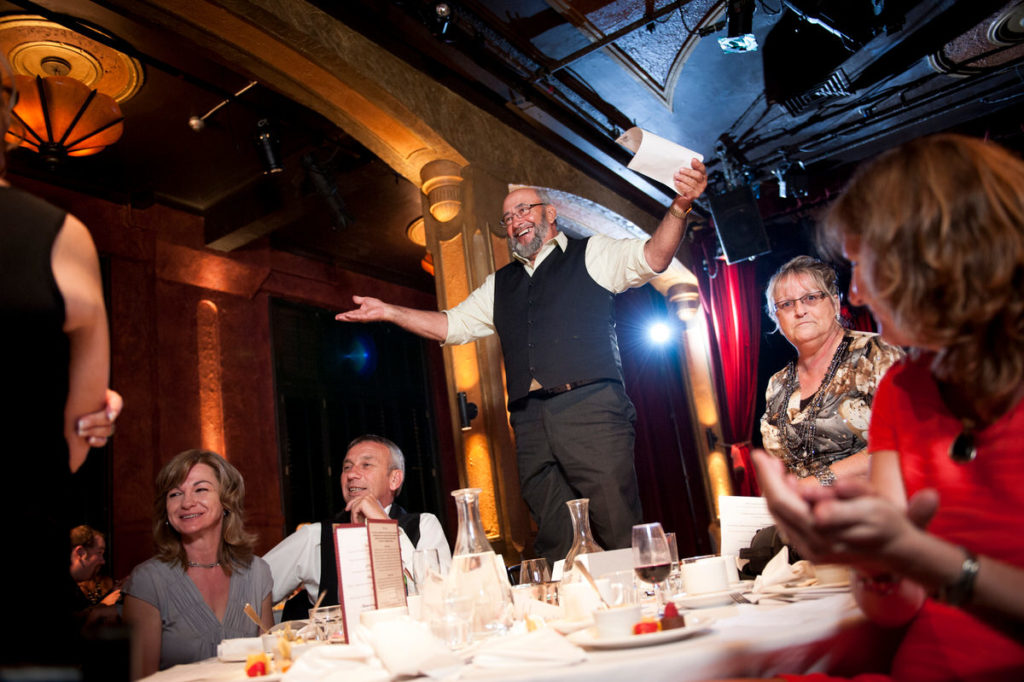 Wedding guest standing up in his chair