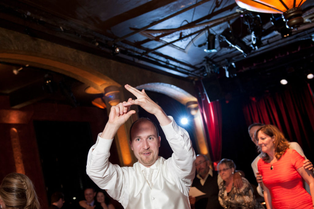 Groom gesturing to his wedding ring