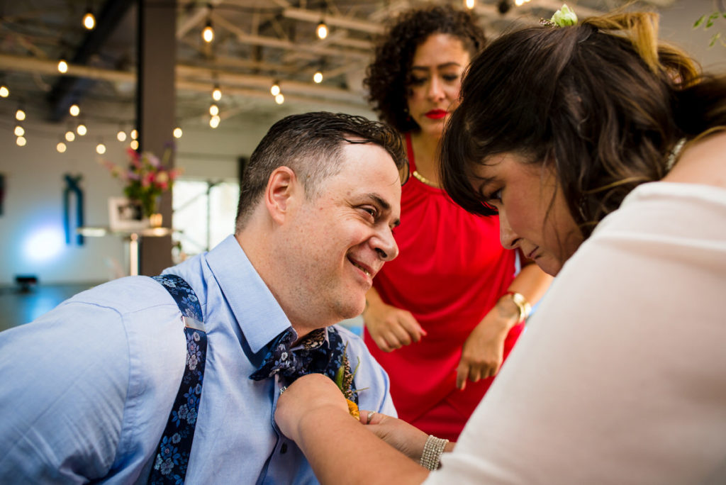 Bride pinning on the groom's boutonnière