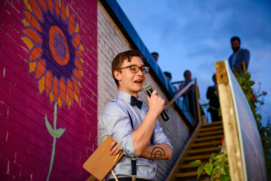 Groom's son giving a speech on the stairs