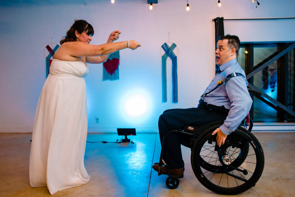 Bride reeling in the groom on the dance floor