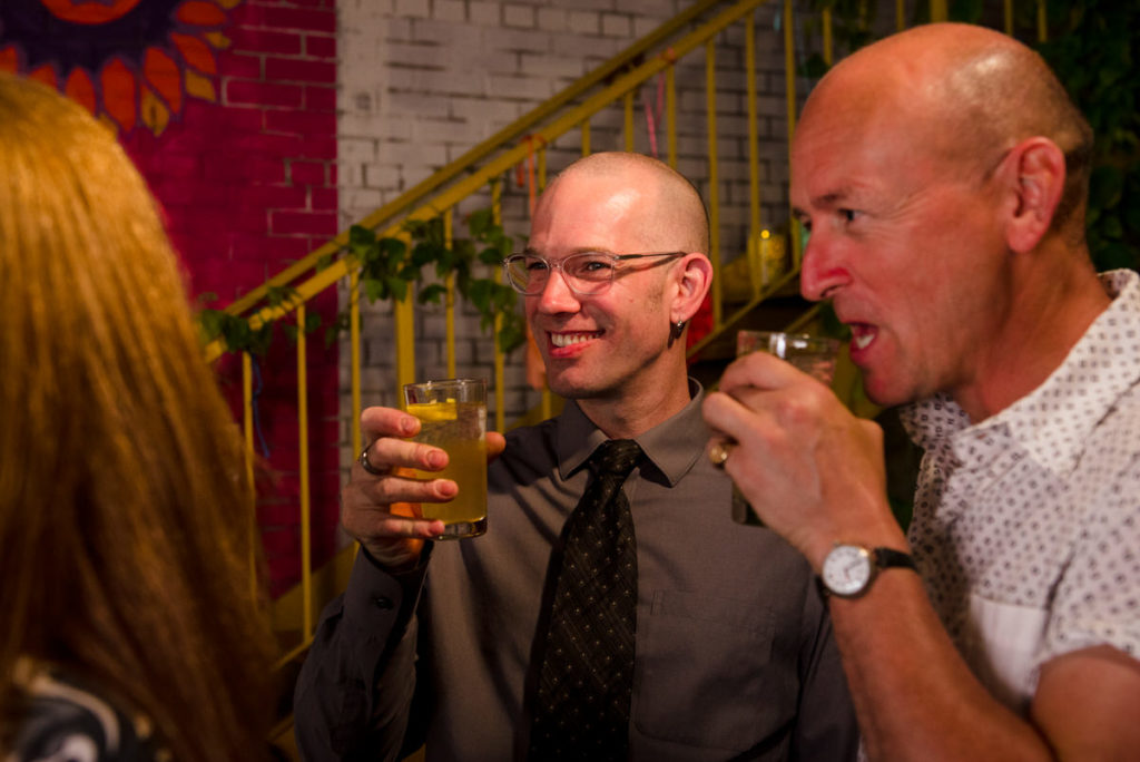 Wedding guests drinking and laughing