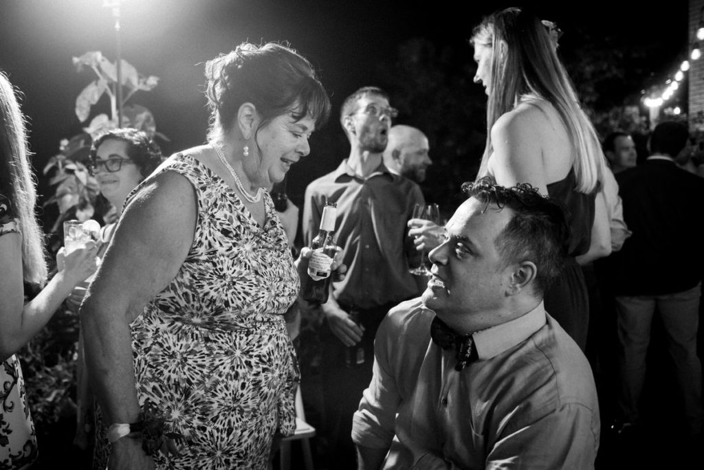 Groom talking with his mom at wedding reception