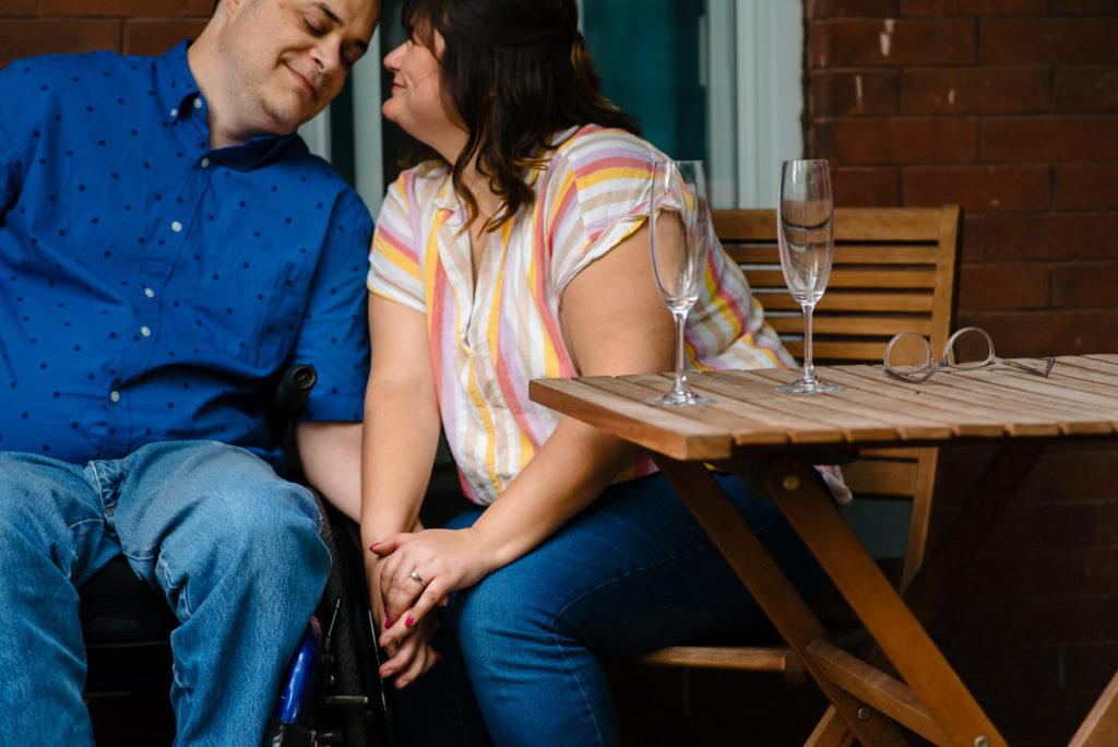 couple holding hands on their front porch