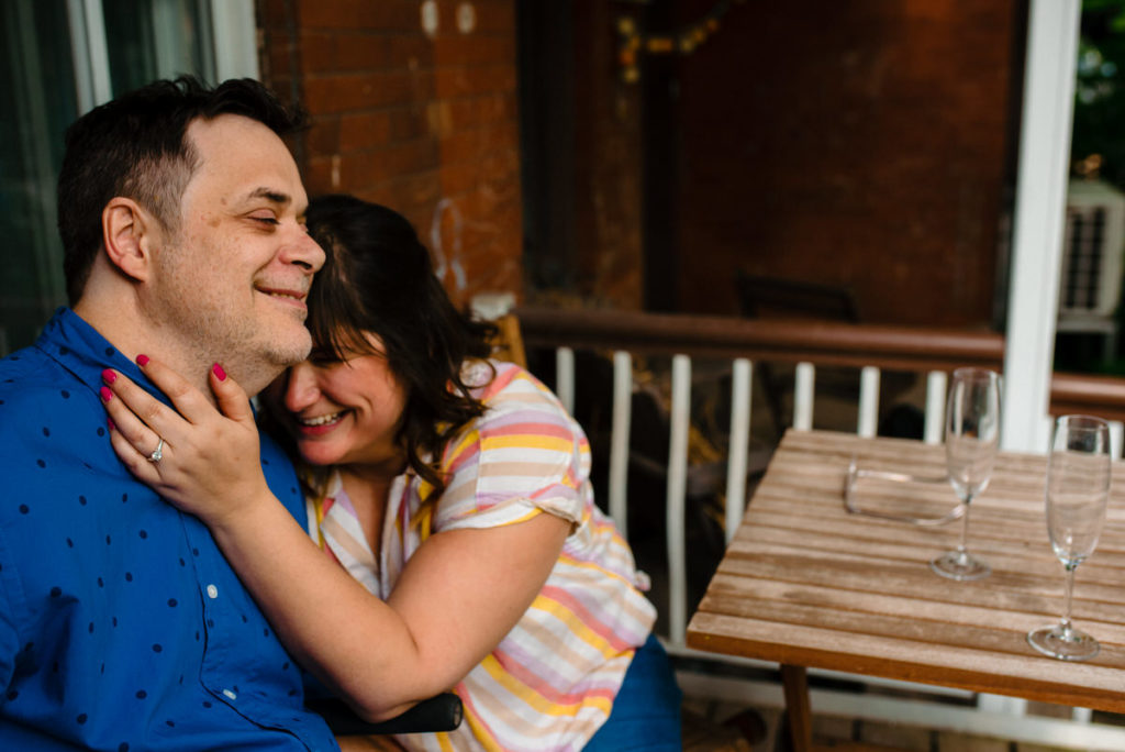 couple cuddling on front porch