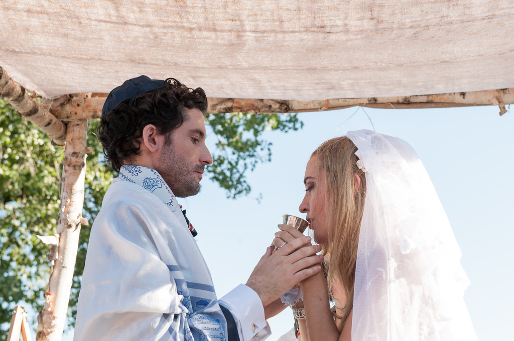 Bride drinking from silver cup at La Vieille Brasserie