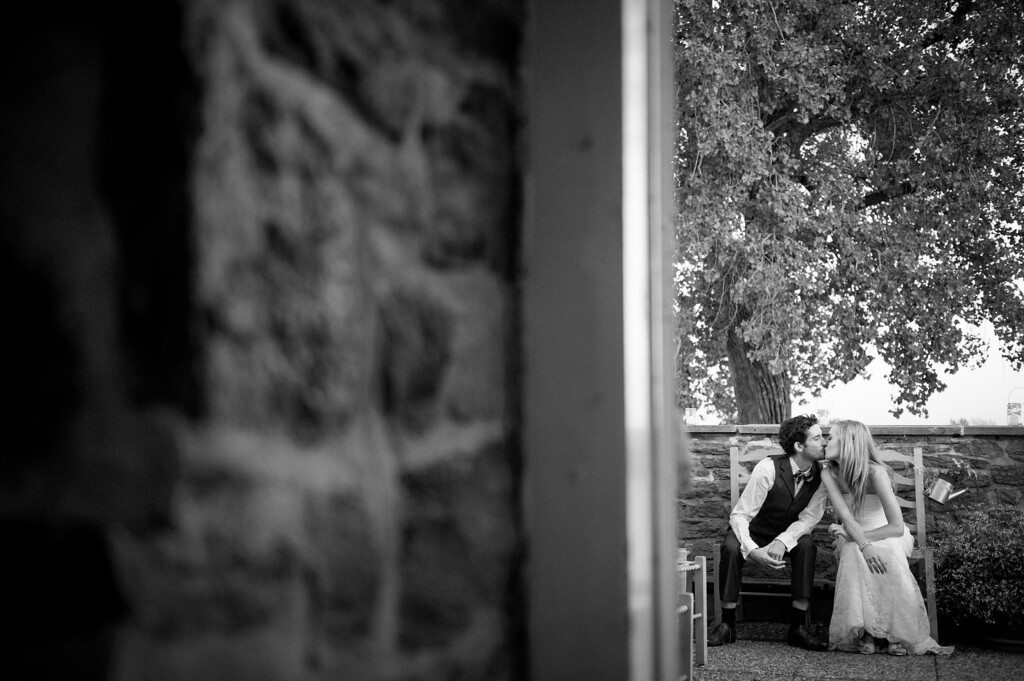 Wedding couple kissing on the porch of La Vieille Brasserie de Lachine