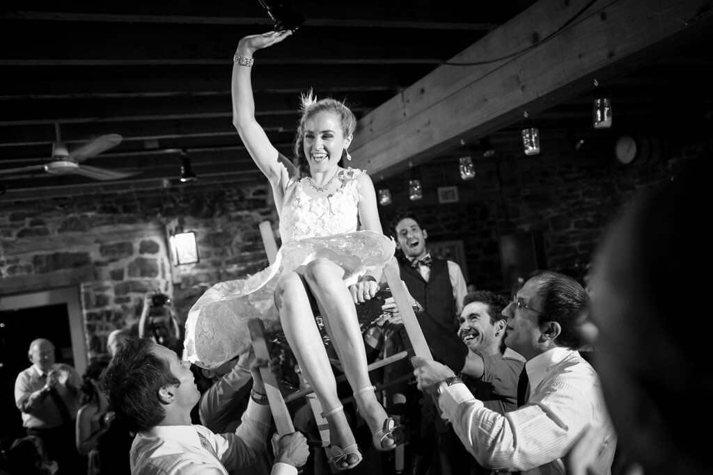 Bride being lifted up on chair