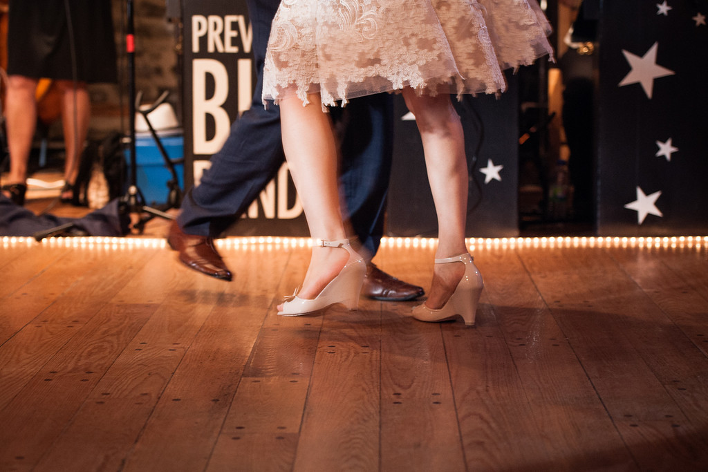 Close up of bride and groom's feet swing dancing