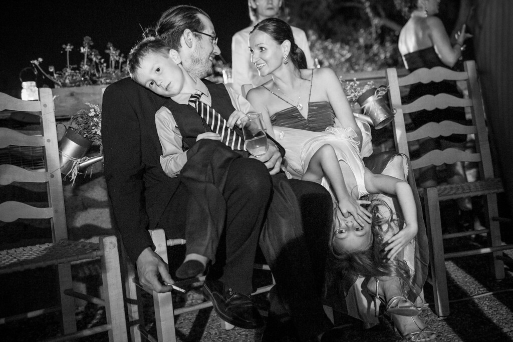 Kids sitting on parents lap at wedding reception