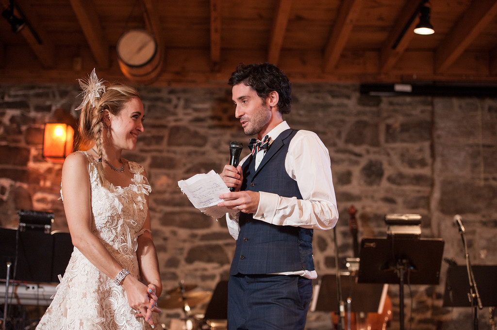 Groom reading speech at wedding reception