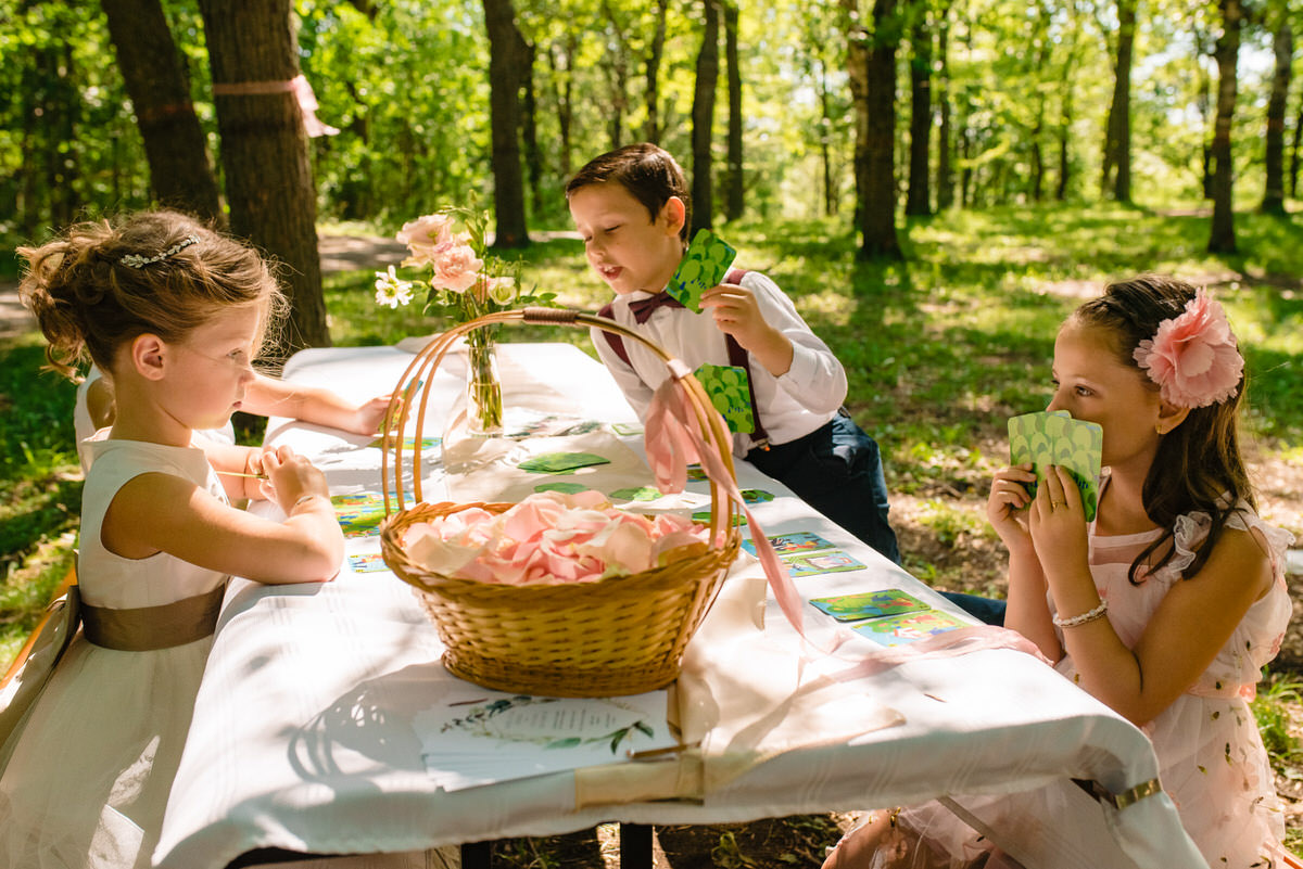 Kids playing cards at picnic table at park wedding