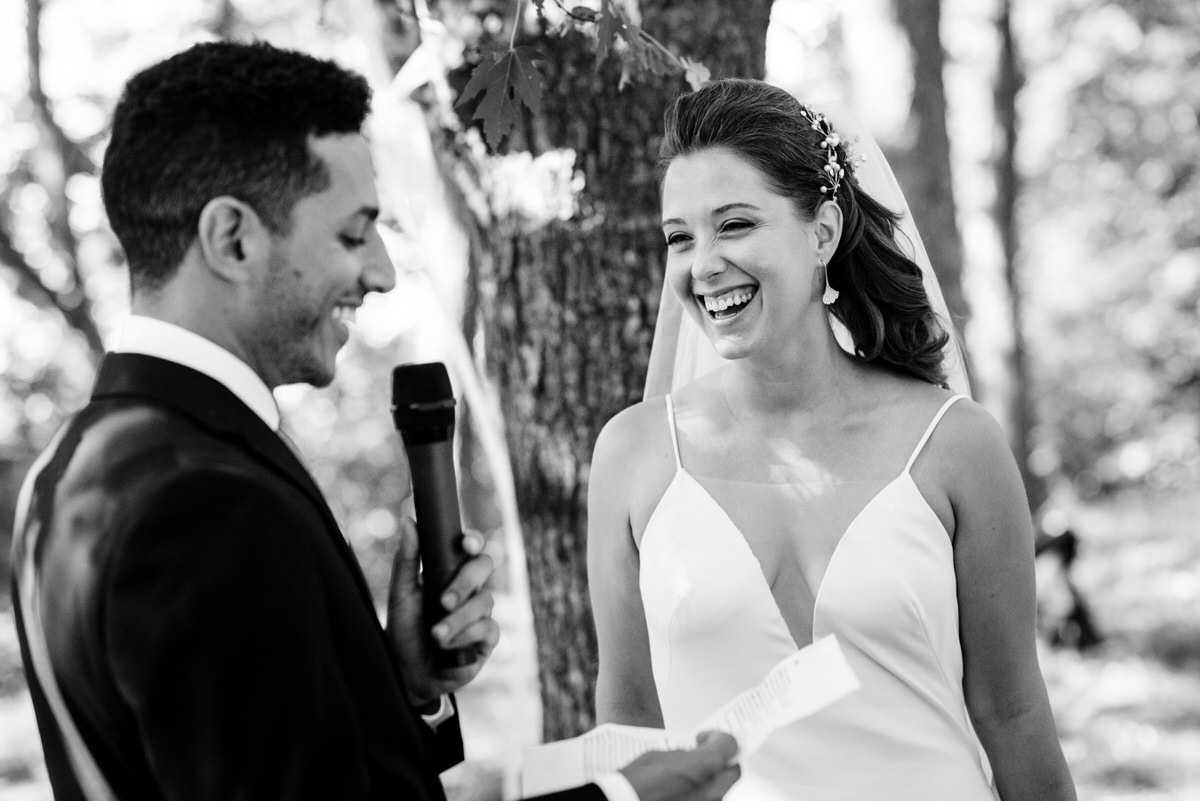 Bride smiling at the groom's wedding vows