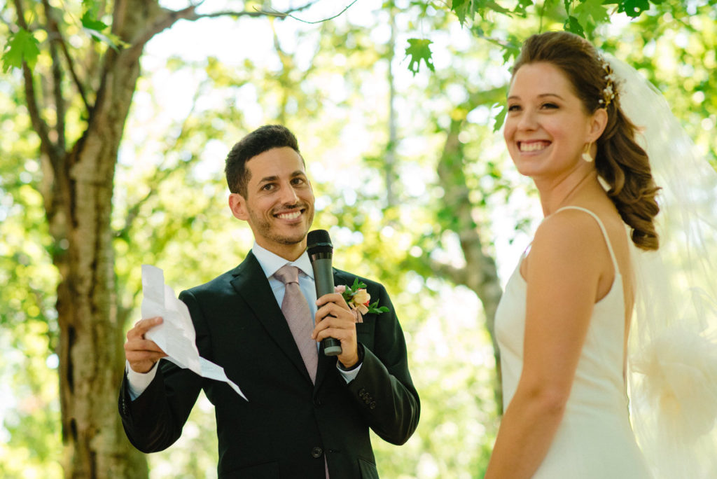 Groom reading his wedding vows at park wedding during the pandemic