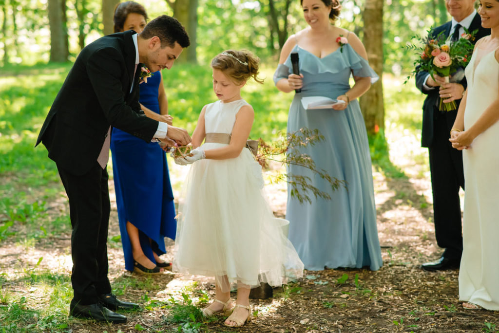 The bride's daughter carrying the rings to the groom