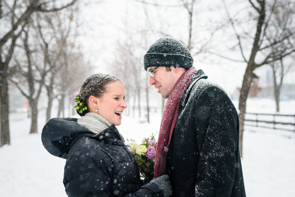 Wedding couple among snowy trees in Old Montreal