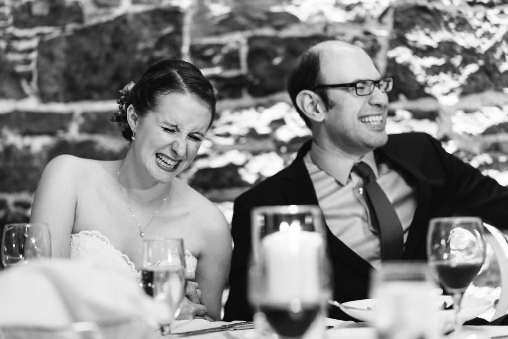 Wedding couple laughing at wedding speech 1