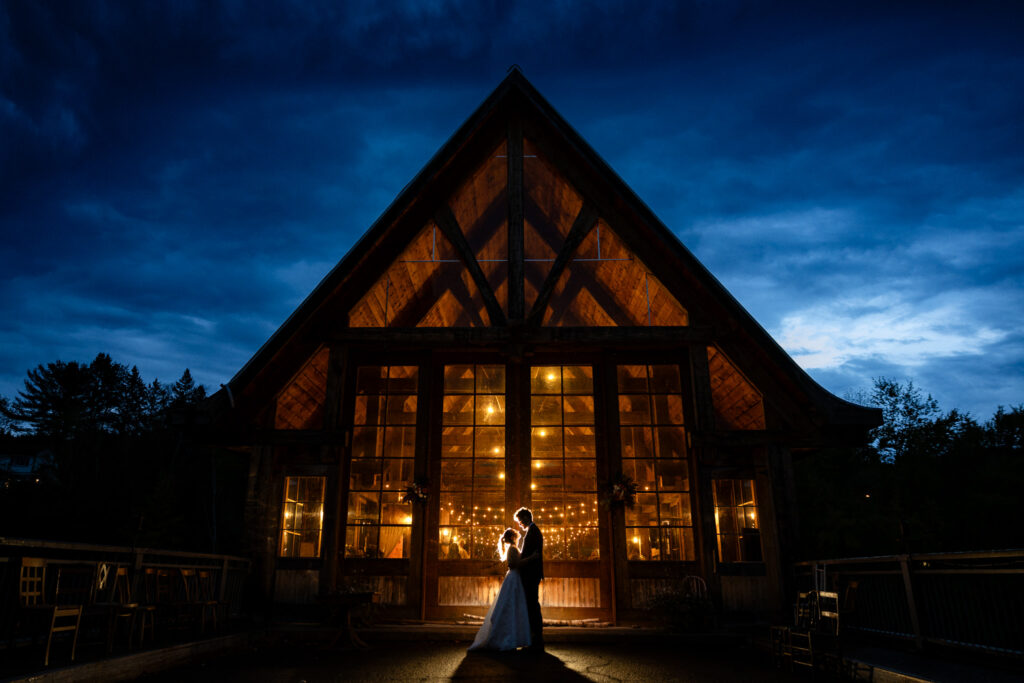 Pont Couvert de La Conception at night with lights shining from within