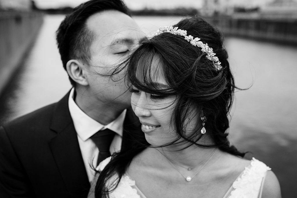 Romantic wedding portrait of couple embracing near the waterfront in Old Montreal