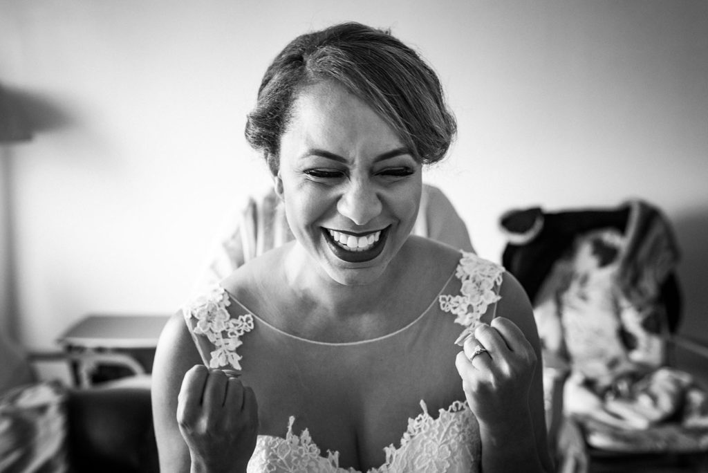 Excited bride grinning and clenching her fists