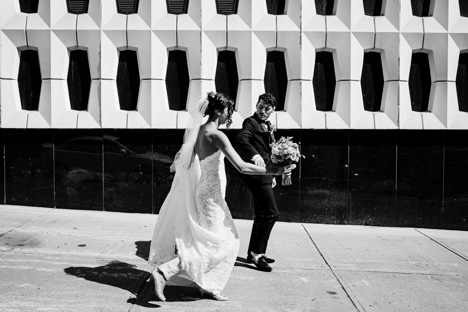 Wedding couple walking past Concordia Hall building