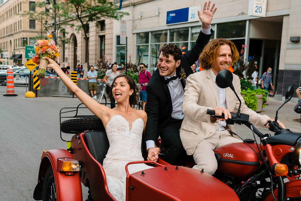 Wedding couple excited to ride off on motorcycle