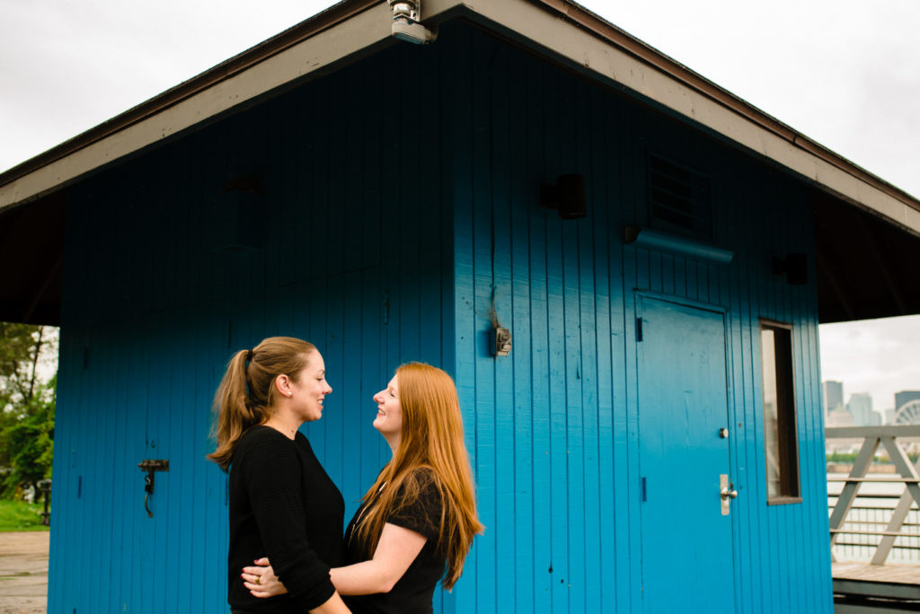 Couple portrait in front of a bright blue shed at Parc Jean-Drapeau
