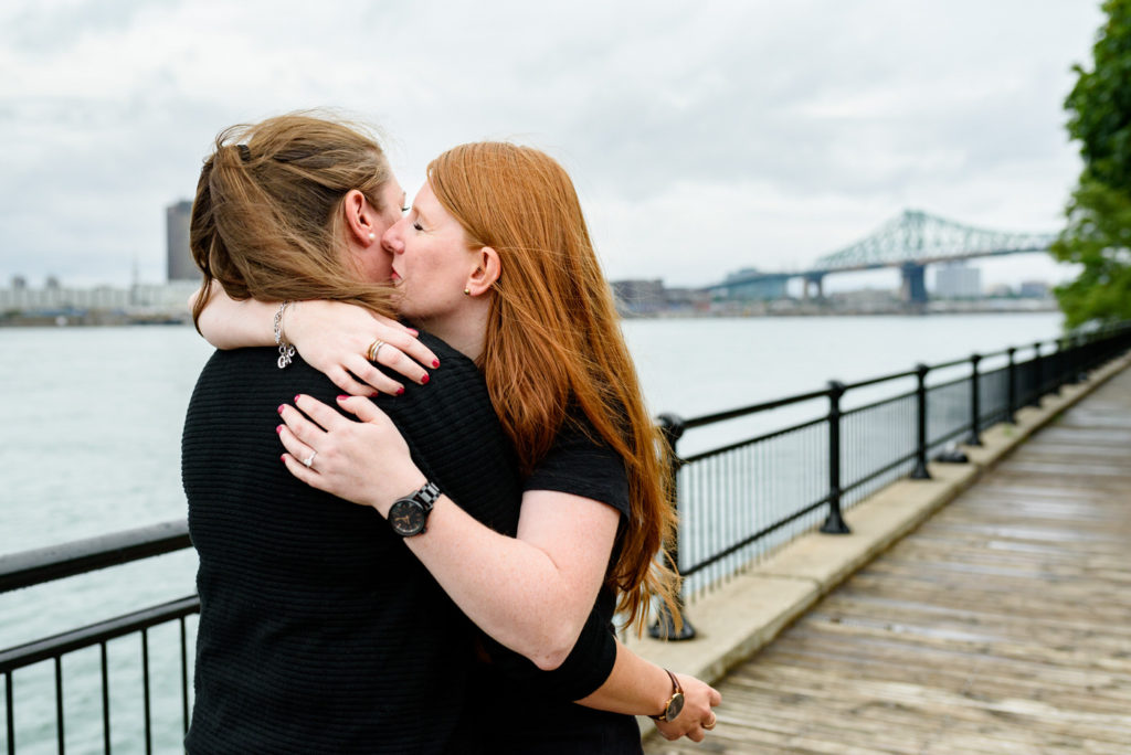 Woman kissing her girlfriend's cheek after the surprise proposal